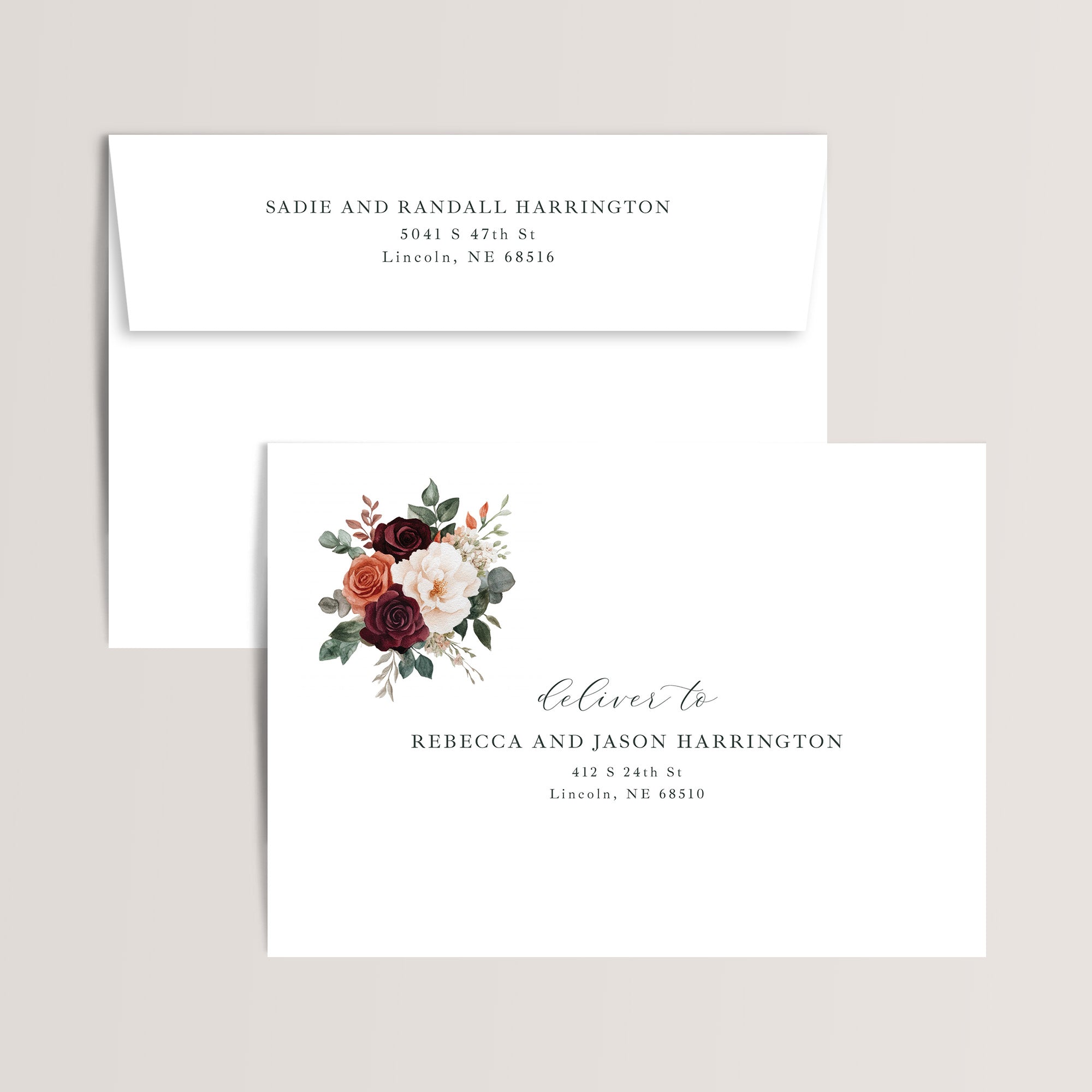 Envelope printing with return address and guest addresses for the burgundy floral wedding invitation suite.