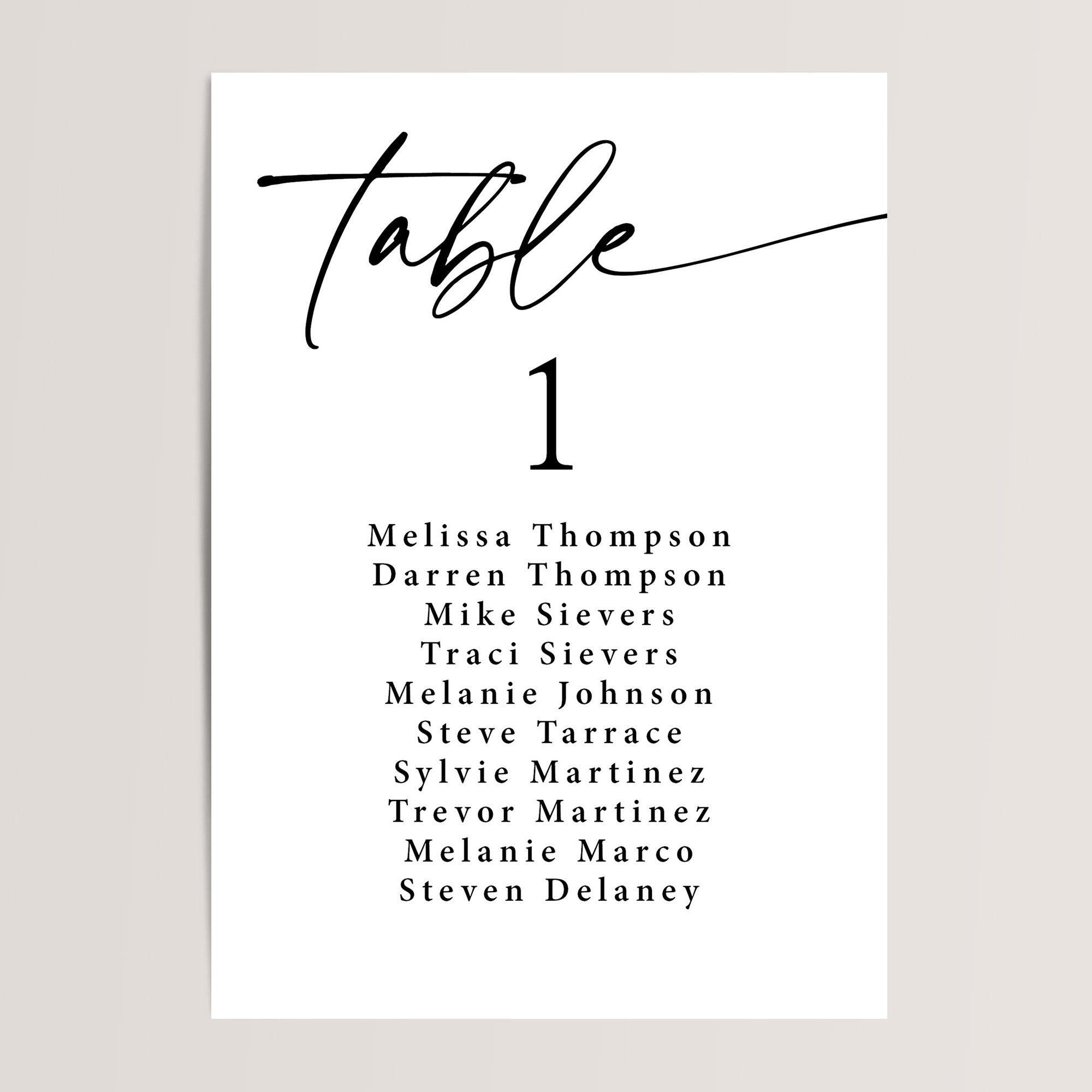 Black and White Seating Chart. Table is in a large script font, below is a large number in a serif font, and guests names listed in a serif font.