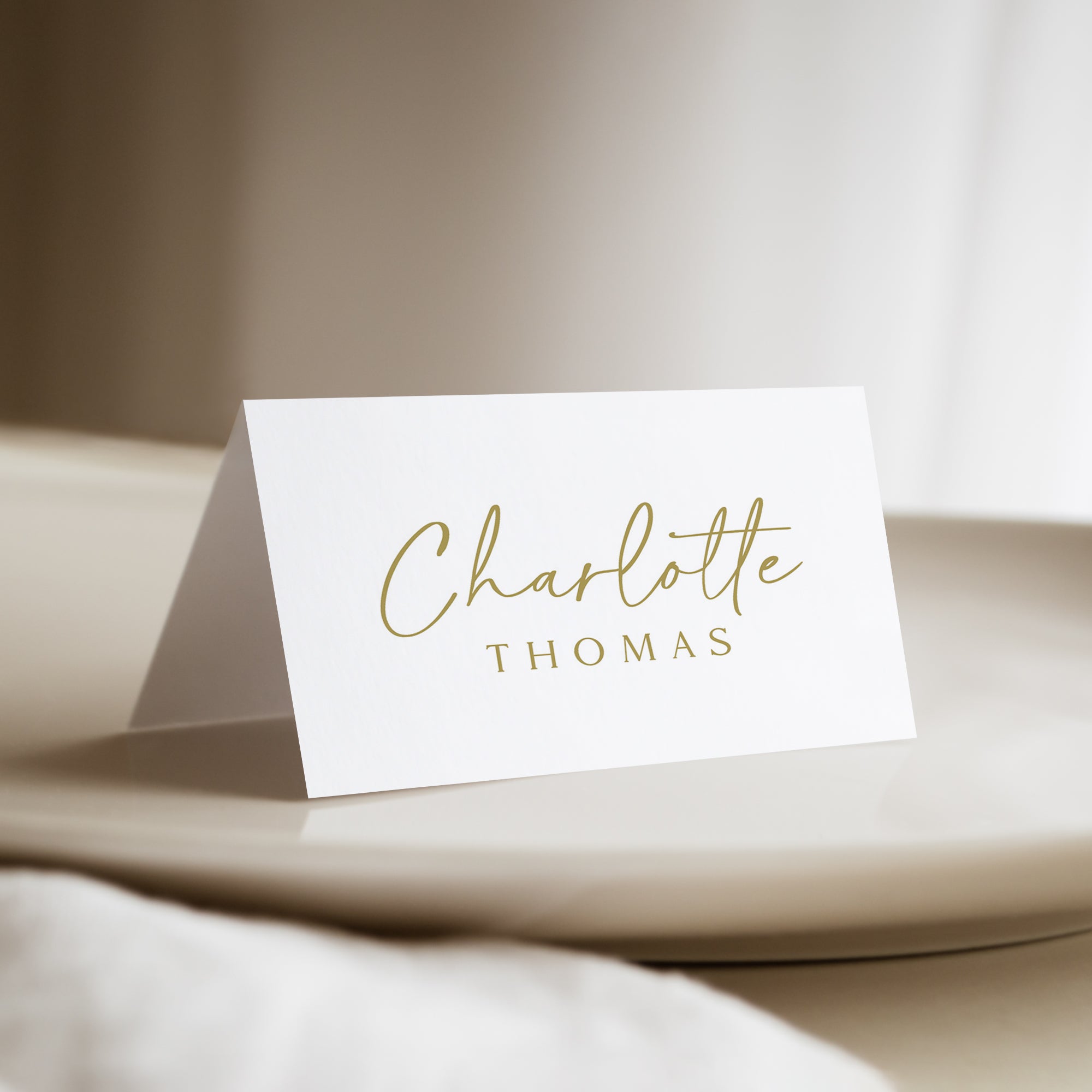 Add a touch of elegance to your wedding reception, rehearsal dinner, birthday party or business party with our personalized wedding place cards. Featuring a minimalist gold and white design with a sophisticated script font, these printed place cards are perfect for any modern or simple wedding.&nbsp;